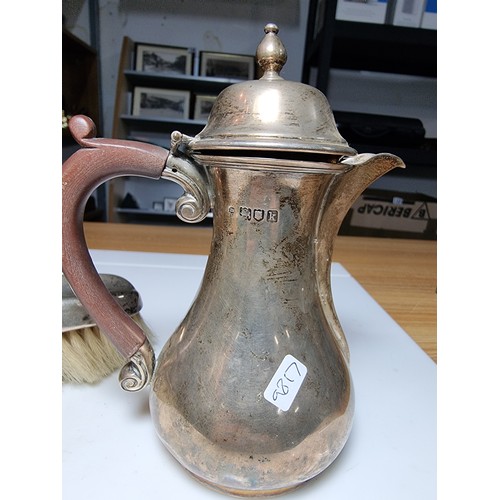 264 - Hallmarked silver lidded small coffee pot along with an hallmarked silver grooming brush. Jug hallma... 