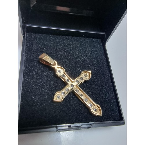 275 - Pretty hallmarked 9ct. yellow gold cross pendant inset with a qty of sparkly CZ stones. In clean con... 