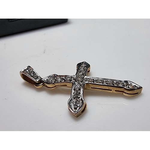 275 - Pretty hallmarked 9ct. yellow gold cross pendant inset with a qty of sparkly CZ stones. In clean con... 