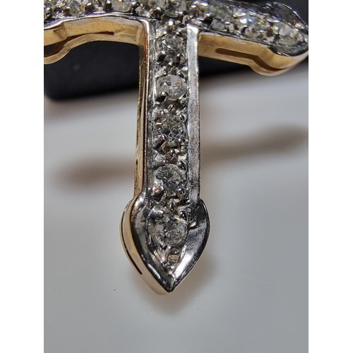 275 - Pretty hallmarked 9ct. yellow gold cross pendant inset with a qty of sparkly CZ stones. In clean con... 