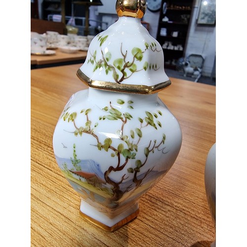 281 - Pair of pretty small hand painted lidded vases by Pintado A Mano both signed TOS, featuring hand pai... 