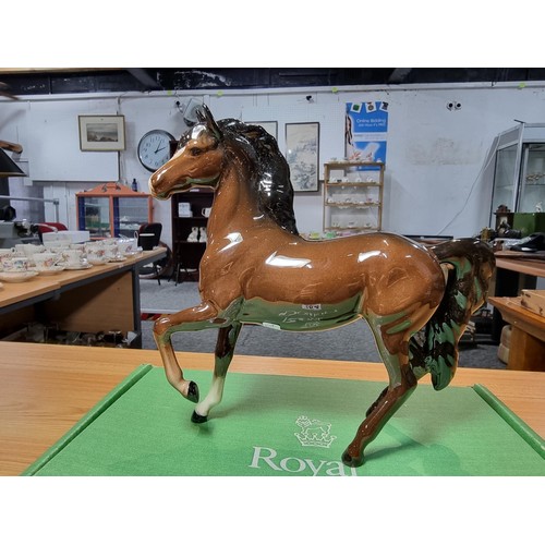 284 - Royal Doulton glazed porcelain horse figure complete with its original box. In excellent clean condi... 