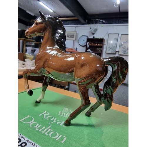 284 - Royal Doulton glazed porcelain horse figure complete with its original box. In excellent clean condi... 