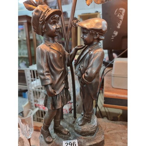 296 - Tall impressive figural lamp featuring cast resin bronze of boy & girl figure, with a two division l... 