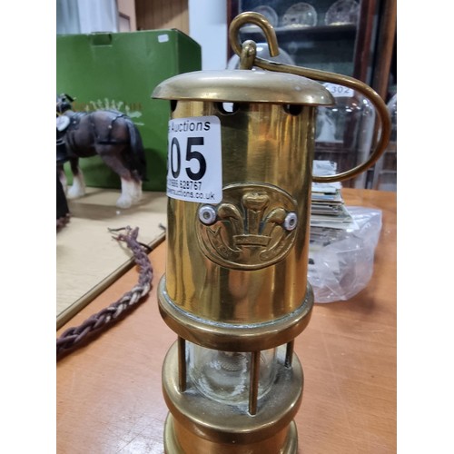 305 - Small brass miners lamp with a Prince of Wales feathers motif, in good order. Height 18cm, diameter ... 