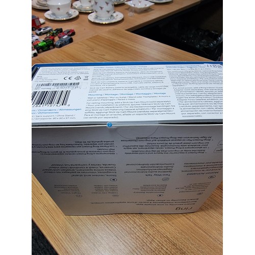 124 - A boxed new and sealed ring stick up cam battery. A battery powered security motion activated camera... 