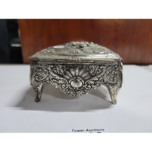 149 - Ornate metal red velvet lined trinket box with ornate design lovers scene to the top, floral designs... 