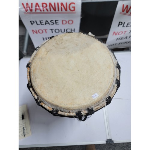 427A - A good quality djembe drum in excellent clean condition having a taut skin standing 46cm high, top d... 