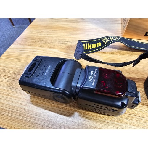 1 - A Nikon D300 digital camera complete with its original box and accessories including a Nikon speed l... 