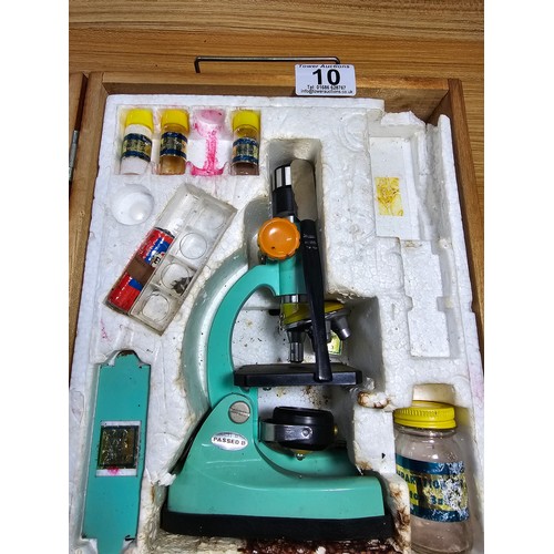 10 - A vintage wooden cased Tasco deluxe microscope set with accessories.