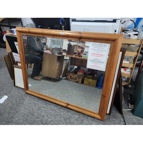 75 - Very large good quality pine framed bevel edged mirror measures 110cm high, 139cm long, has screw fi... 