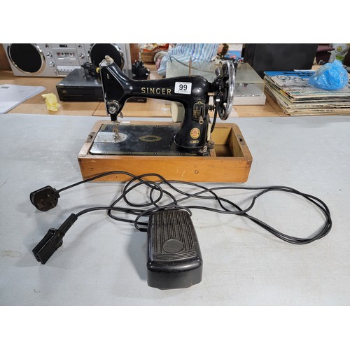 99 - Vintage electric 99k Singer sewing machine complete with foot pedal, in need of new rope for the whe... 