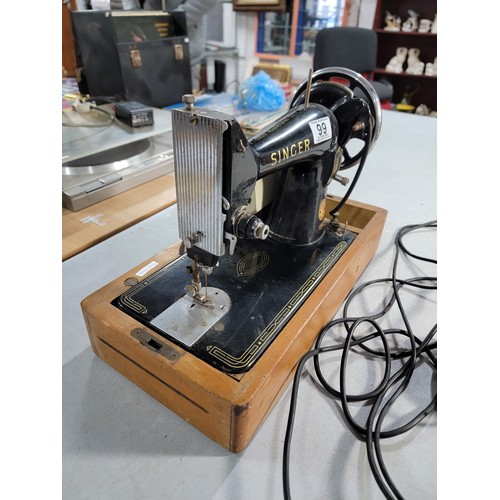 99 - Vintage electric 99k Singer sewing machine complete with foot pedal, in need of new rope for the whe... 