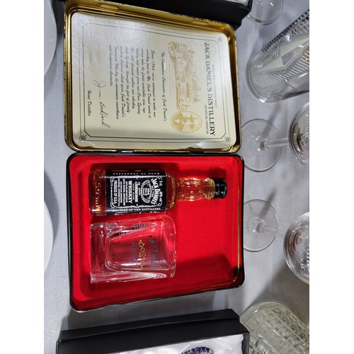 107 - A box of glassware including a collectors mini Jack Daniels tin, 6x Henessy cognac glasses, along wi... 