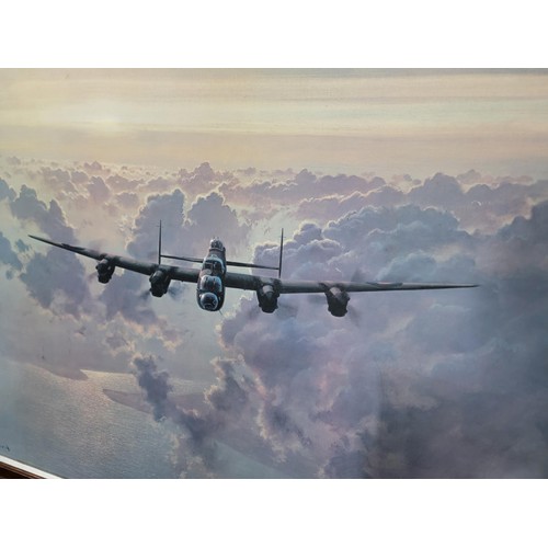119 - Large framed print of a Lancaster bomber flying over the clouds by Coulson, height 66cm length 85cm