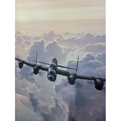 119 - Large framed print of a Lancaster bomber flying over the clouds by Coulson, height 66cm length 85cm