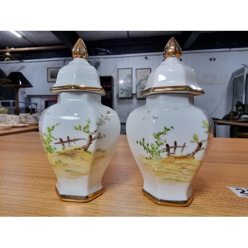 178 - Pair of pretty small hand painted lidded vases by Pintado A Mano both signed TOS, featuring hand pai... 