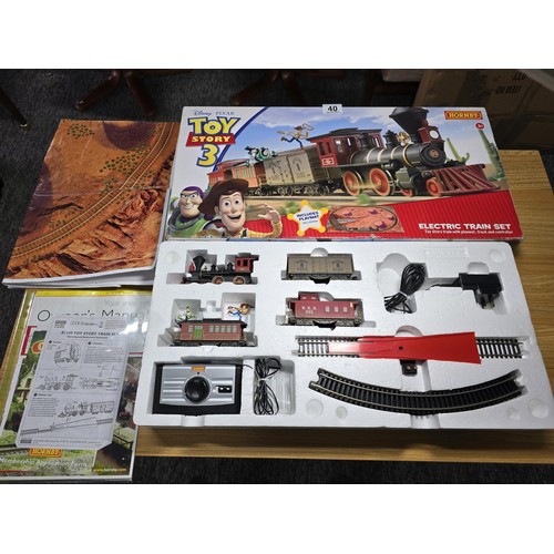 40 - A rare Hornby R1149 Toy Story 3 train set, all boxed with track mat and all paperwork, with controll... 