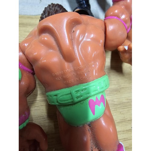 60 - A collection of 11x WWF (Now WWE) wrestling figures all from 1990 and 1991 along with 6x ladybird th... 