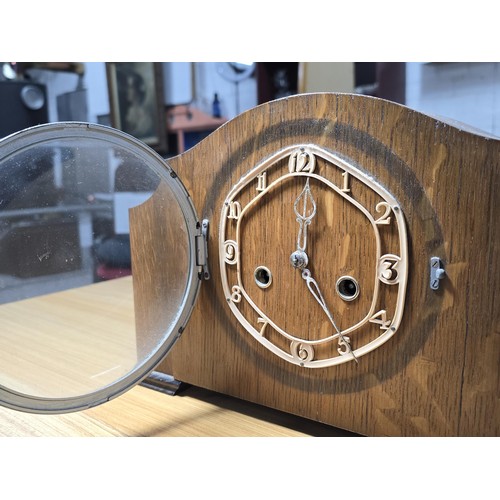 186 - A vintage oak mantel clock with an unusual pierced dial having an Enfield 8 day movement and complet... 