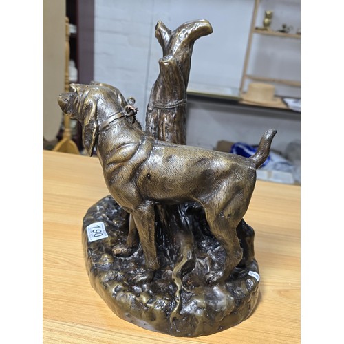 190 - A large and impressive solid bronze sculpture of 2 hunting hounds tied to a tree stump by Grace Mott... 