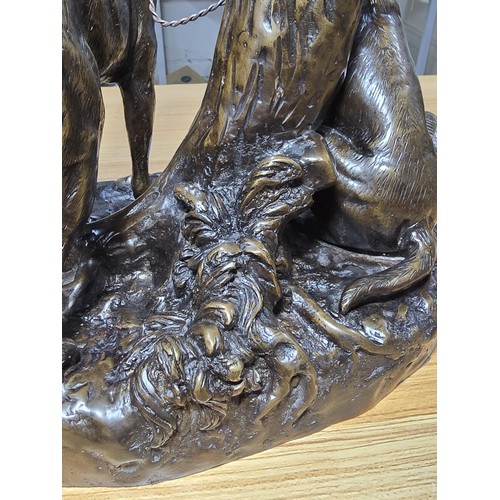 190 - A large and impressive solid bronze sculpture of 2 hunting hounds tied to a tree stump by Grace Mott... 