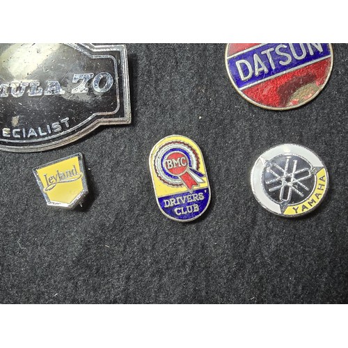 191 - A large collection of approx 35x collectable pin badges on a black display board (included) to inclu... 