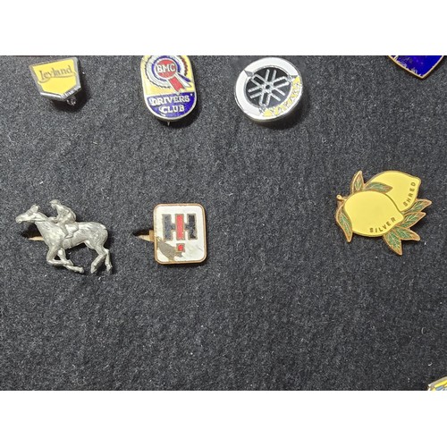 191 - A large collection of approx 35x collectable pin badges on a black display board (included) to inclu... 