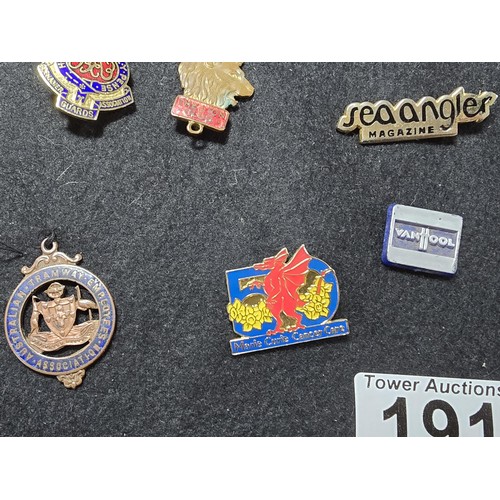 191 - A large collection of approx 35x collectable pin badges on a black display board (included) to inclu... 