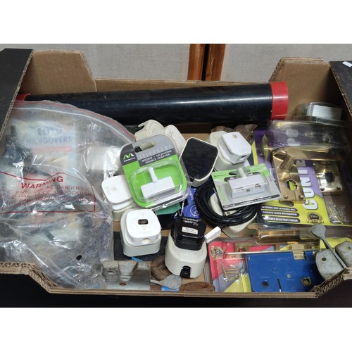 385 - A box containing a quantity of various household items to include various plug adaptors, door handle... 