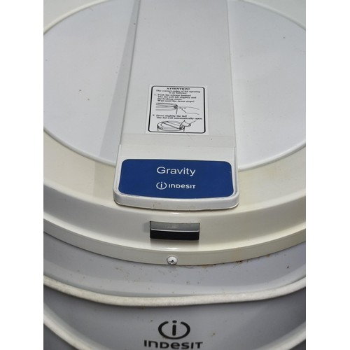 395 - An Indesit IPX4 Gravity spin dryer, complete with power cable and plastic clothes cover, stands at 6... 