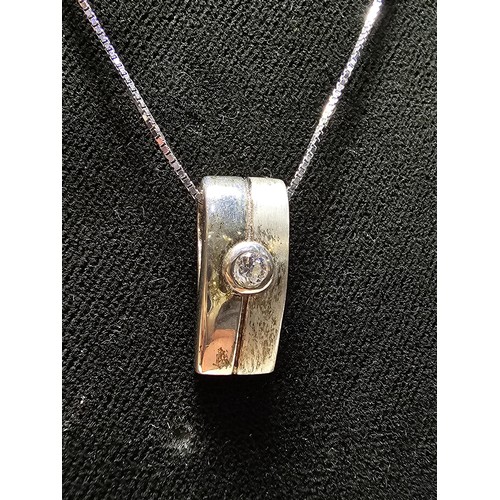 205 - A 925 silver pendant inset with a CZ crystal stone on an 18