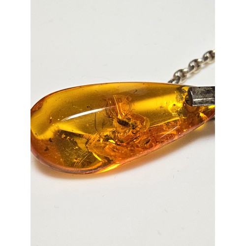 208 - An impressive genuine Baltic amber specimen pendant inset with real inset inclusions which includes ... 