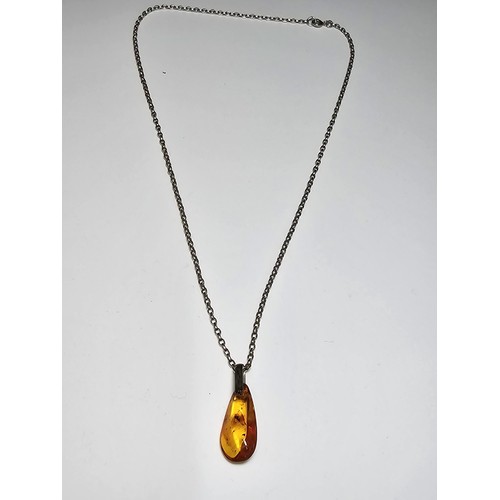 208 - An impressive genuine Baltic amber specimen pendant inset with real inset inclusions which includes ... 