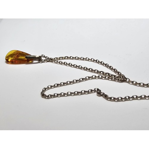 208 - An impressive genuine Baltic amber specimen pendant inset with real inset inclusions which includes ... 