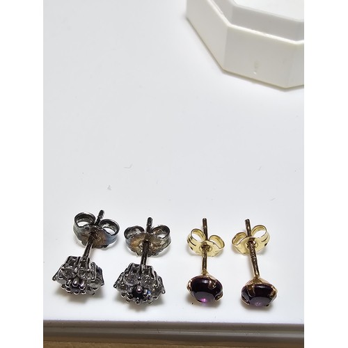 209 - 2 pairs of stud earrings to include a pair of 9ct gold stud earrings inset with amethyst stones alon... 