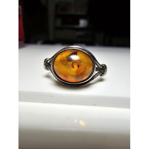 213 - A vintage 925 silver ring inset with a large oval genuine amber stone, in clean condition and boxed.... 