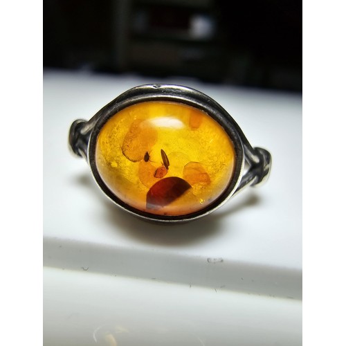 213 - A vintage 925 silver ring inset with a large oval genuine amber stone, in clean condition and boxed.... 