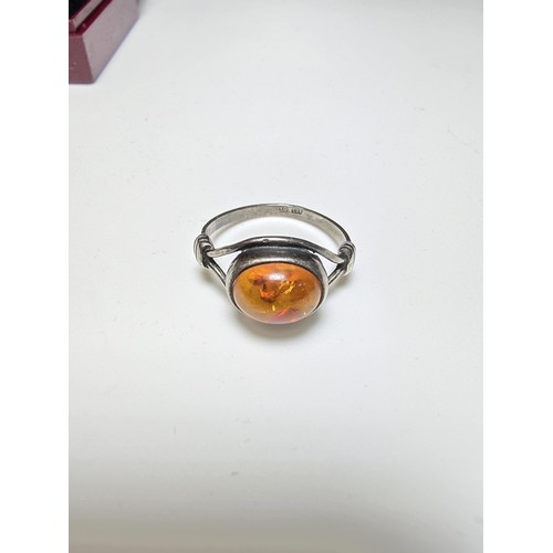 213 - A vintage 925 silver ring inset with a large oval genuine amber stone, in clean condition and boxed.... 