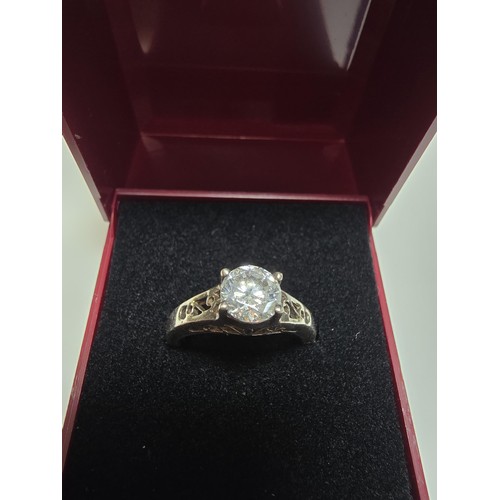 214 - A chunky 925 silver dress ring with a pierced design inset with a large CZ crystal sparkly stone. In... 