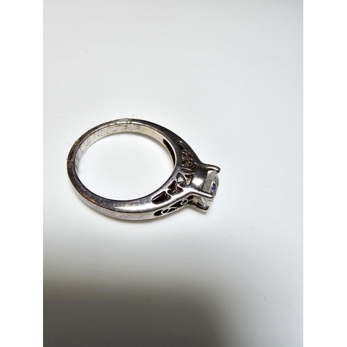 214 - A chunky 925 silver dress ring with a pierced design inset with a large CZ crystal sparkly stone. In... 