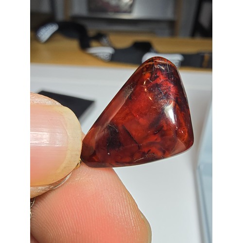 215 - A stunning deep red genuine amber pendant which displays very nicely with light shining through it. ... 