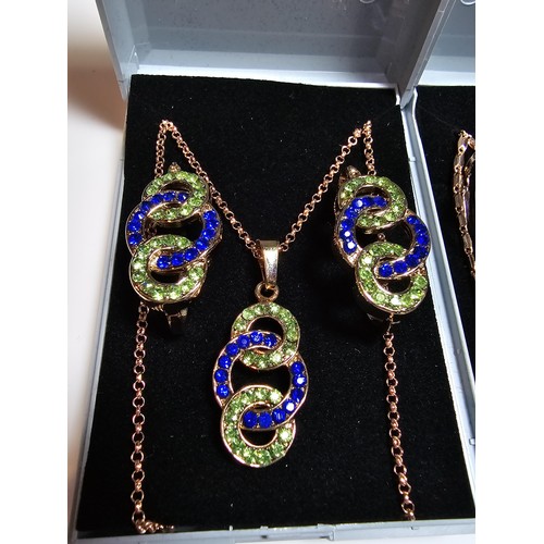 220 - 2x rose gold plated matching jewellery set to include a necklace and earring set inset with blue and... 