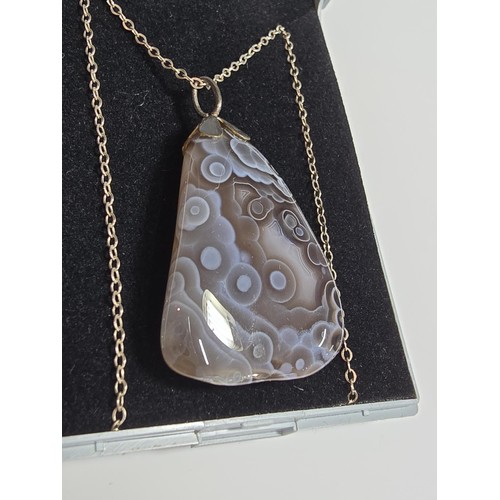 222 - A large crazy lace agate pendant with an interesting natural design, on an 18