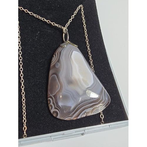 222 - A large crazy lace agate pendant with an interesting natural design, on an 18