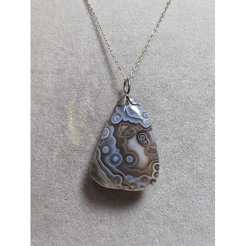 222 - A large crazy lace agate pendant with an interesting natural design, on an 18