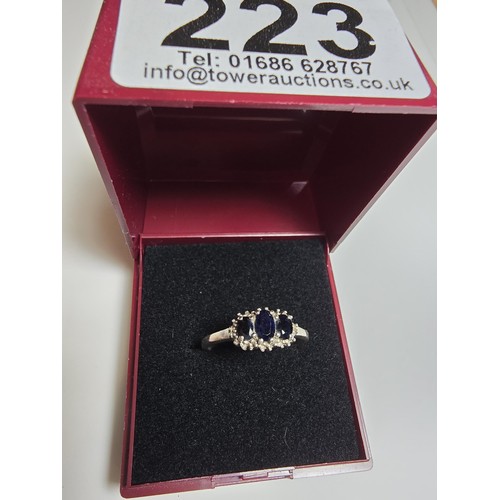 223 - A 925 silver 3 stone ring inset with genuine blue sapphire stones in good clean condition and boxed,... 