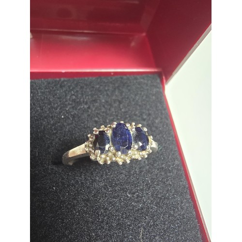 223 - A 925 silver 3 stone ring inset with genuine blue sapphire stones in good clean condition and boxed,... 