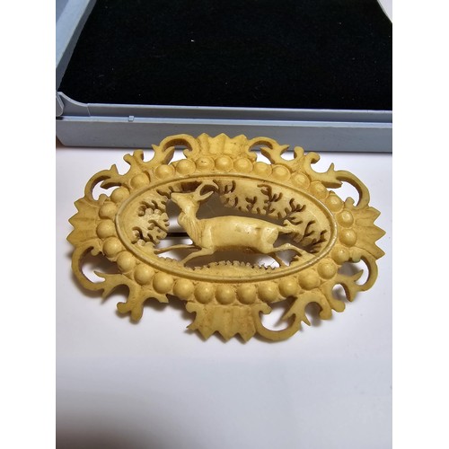 225 - A good vintage well carved antler brooch with a deer scene to the centre, minor damage to the decora... 