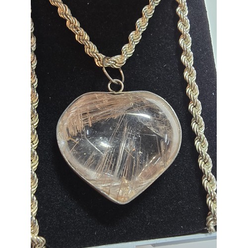 228 - An impressive 925 silver rutilated quartz heart formed pendant set on a good chunky 20